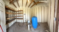 a room with a blue water tank and shelves